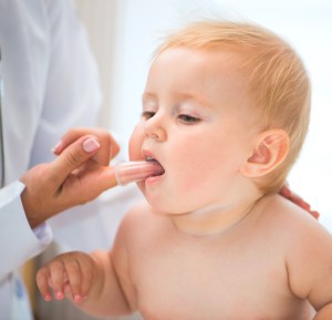 dentist checking an infants mouth
