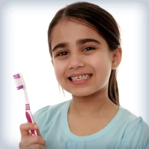 child holding a toothbrush