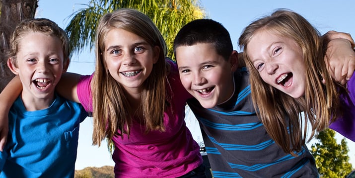 4 smiling kids